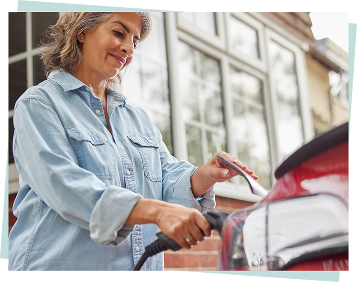Image of a person charging an electric vehicle.